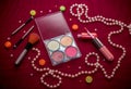 Makeup cosmetic kit Ã¢â¬â eye shadows, highlighter, lip gloss and blush, brushes and pink string of pearls Royalty Free Stock Photo
